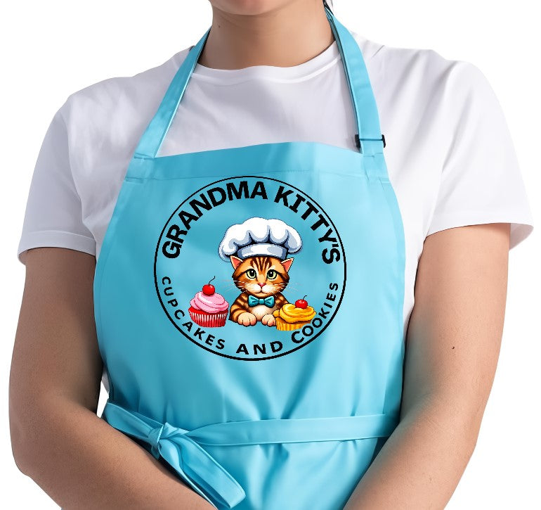 Grandma Kitty’s blue adjustable chef apron with cupcakes and cookies logo
