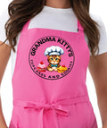Grandma Kitty’s pink adjustable chef apron with cupcakes and cookies logo