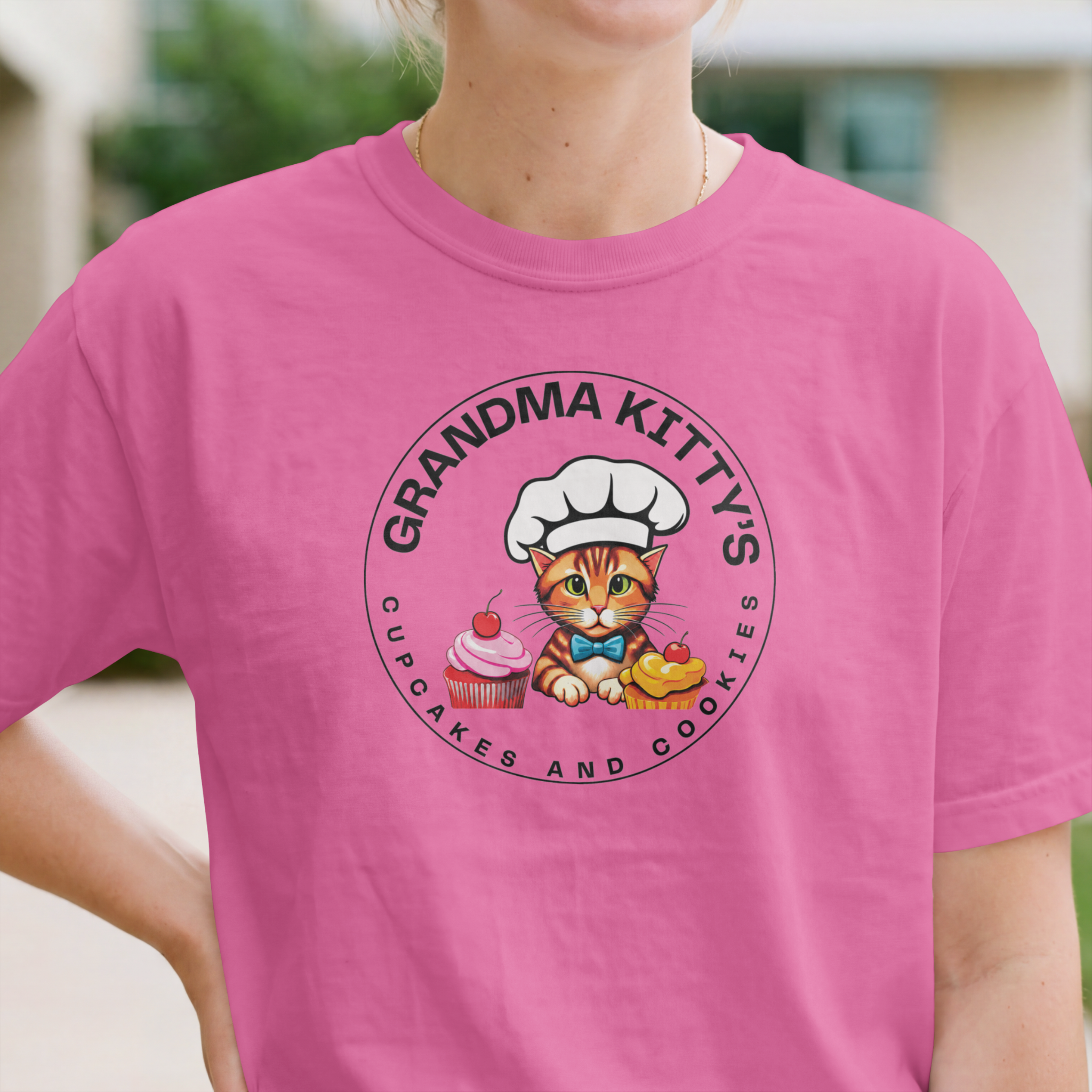Grandma Kitty’s pink t-shirt with cupcakes and cookies logo